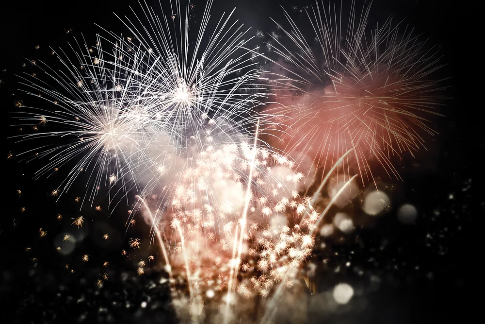 Colorful fireworks bursting in night sky during New Year celebration